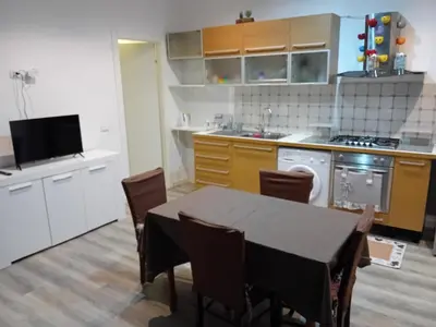 a kitchen with a table and chairs in a kitchen at Vernagallo's house in Palermo