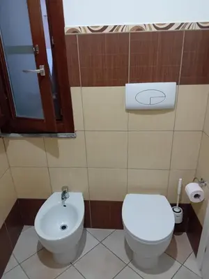 a bathroom with a toilet and a sink at Vernagallo's house in Palermo