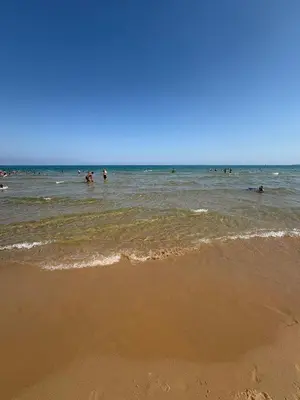 a group of people in the water at the beach at Dimora Anastasia - Alloggio nel cuore di Balestrate in Balestrate