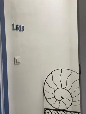 a room with a door with a sign on the wall at PHI-Lampara in Santa Flavia