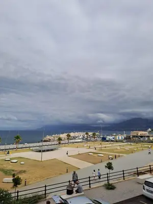 a park with people walking around in a field at PHI-Lampara in Santa Flavia