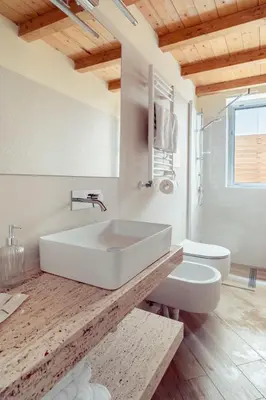 a white bathroom with a sink and a toilet at Casa Clio - Mondello Home in Palermo