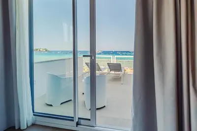 a room with a balcony with a view of the ocean at Hybrid Icon Rooms Gallery in Palermo