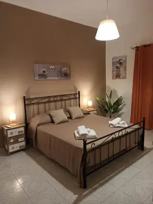 a bedroom with a bed with two towels on it at Lucy home in Palermo