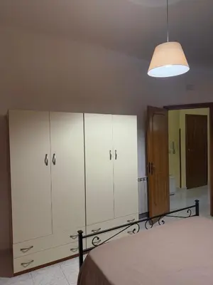 a bedroom with white cabinets and a bed in it at Lucy home in Palermo