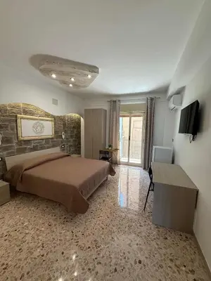 a bedroom with a bed and a green light at nuova oreto stazione rooms in Palermo
