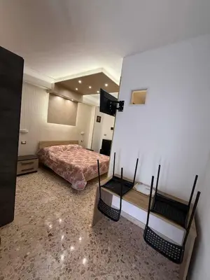 a bedroom with a bed and two paintings on the wall at nuova oreto stazione rooms in Palermo