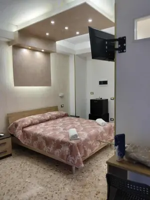 a bedroom with a bed in a room with at nuova oreto stazione rooms in Palermo