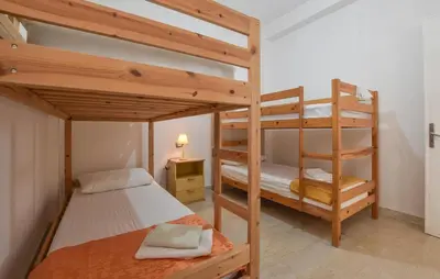 a bedroom with two bunk beds and a lamp at Amazing Apartment In Trappeto With Wifi in Trappeto