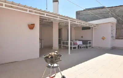 a balcony of a white building with a bowl on a tripod at Amazing Apartment In Trappeto With Wifi in Trappeto