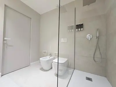 a bathroom with a toilet and a glass shower at Dolce Dormire in Palermo