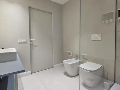 a white bathroom with a toilet and a sink at Dolce Dormire in Palermo