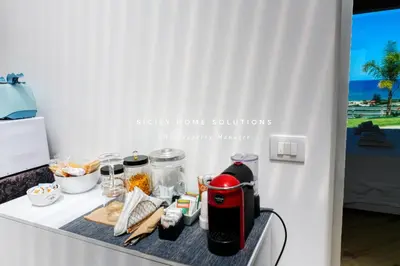 a kitchen counter with a table with food on it at Appartamento in villa vista mare con jacuzzi By Sicily Home Solutions in Balestrate