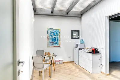 a dining area with a table and chairs in a room at Appartamento in villa vista mare con jacuzzi By Sicily Home Solutions in Balestrate