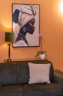 a painting of a woman on a wall above a couch at 4Quarti in Palermo