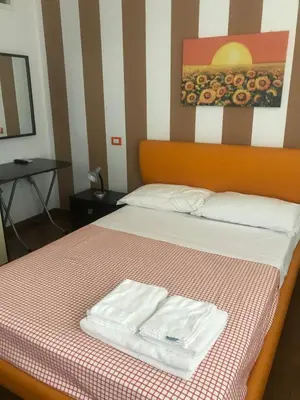 a hotel room with a bed with two towels on it at b&b Simpaty in Mondello