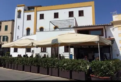 a restaurant with umbrellas in front of a building at b&b Simpaty in Mondello
