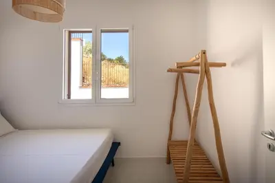 a bedroom with a bed and a window at Sea Frame Design Apartments with Pool by Wonderful Italy in Santa Flavia