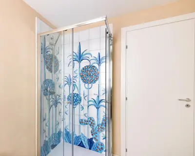 a shower with a glass door in a bathroom at Sea Frame Design Apartments with Pool by Wonderful Italy in Santa Flavia