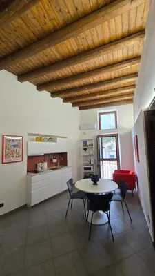 a kitchen and dining room with a table and chairs at Qanat House con Terrazzo Privato in Palermo