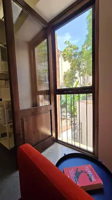a room with a red couch and a window at Qanat House con Terrazzo Privato in Palermo