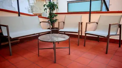 a group of chairs and a table in a room at Qanat House con Terrazzo Privato in Palermo