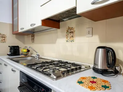 a kitchen with a stove top oven and a counter top at Dimora Puccini by Holiday World in Castellammare del Golfo