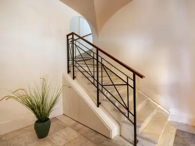 a staircase with a metal rail and a mirror at Dimora Puccini by Holiday World in Castellammare del Golfo