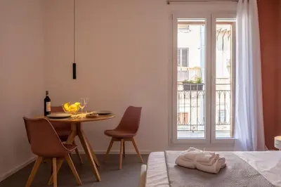 a room with a table and chairs and a window at Corallo - Cantunera Old Town Apartments in Palermo