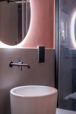 a bathroom with a white sink and a mirror at Corallo - Cantunera Old Town Apartments in Palermo