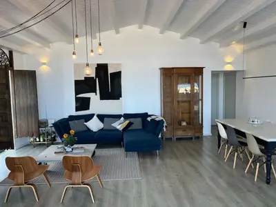 a living room with a blue couch and a table at Casa Mulinazzo in Cinisi