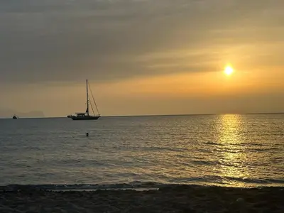 a sail boat in the ocean at sunset at Casa Mulinazzo in Cinisi