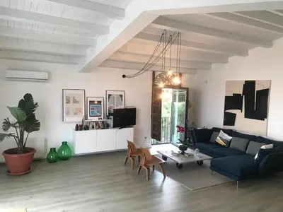 a living room with a blue couch and a table at Casa Mulinazzo in Cinisi
