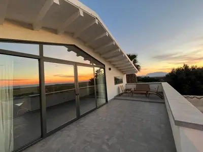 a balcony of a house with a view of the sunset at Casa Mulinazzo in Cinisi