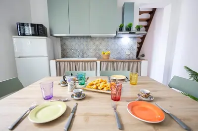 a wooden table with plates and utensils on it at inHouse Palermo in Palermo