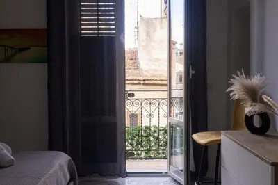 a room with a door open to a balcony at inHouse Palermo in Palermo