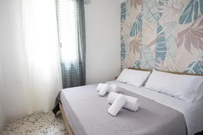 a bedroom with a bed with two towels on it at inHouse Palermo in Palermo