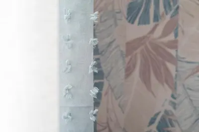 a curtain with flowers on it with a wall at inHouse Palermo in Palermo