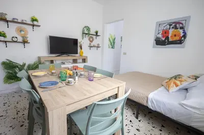 a room with a table with chairs and a bed at inHouse Palermo in Palermo