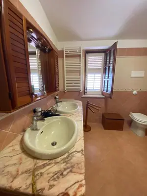 a bathroom with two sinks and a toilet at Casa Mini' in Palermo