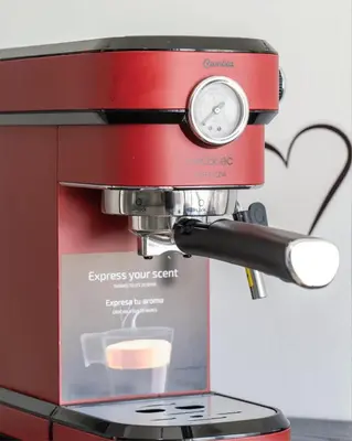 a red coffee machine sitting on a table at Airoldi Home in Palermo