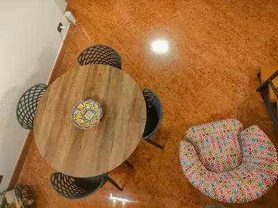 a wooden table and chairs in a room at Bellini al Massimo in Palermo