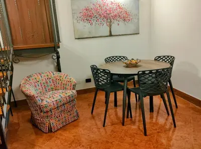 a dining room table and chairs and a chair at Bellini al Massimo in Palermo
