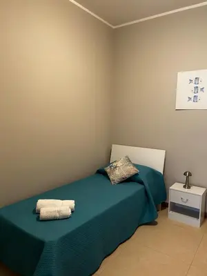 a bedroom with a bed with two towels on it at Sole Blue Apartment in Balestrate