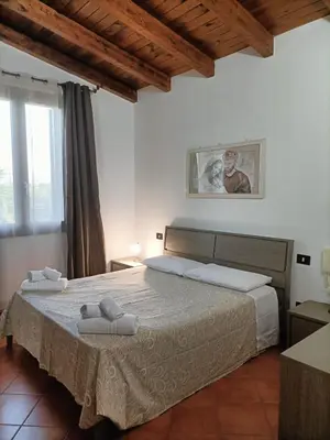 a bedroom with a bed with towels on it at CAGNINA Apartments in Balestrate