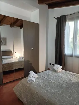 a bedroom with two towels on a bed and a mirror at CAGNINA Apartments in Balestrate