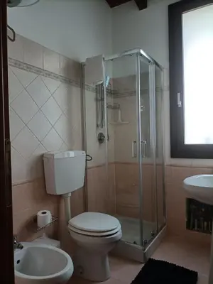 a bathroom with a shower and a toilet and a sink at CAGNINA Apartments in Balestrate