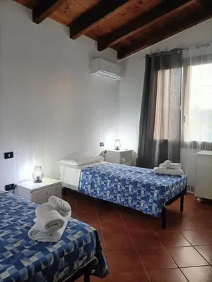 a room with two beds and a window at CAGNINA Apartments in Balestrate