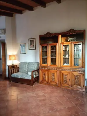 a living room with a couch and a china cabinet at CAGNINA Apartments in Balestrate