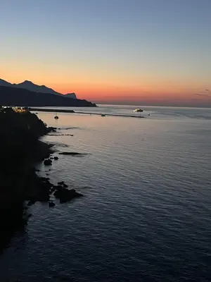 a sunset over a body of water with boats in it at Casa Sole e Limone in Castellammare del Golfo
